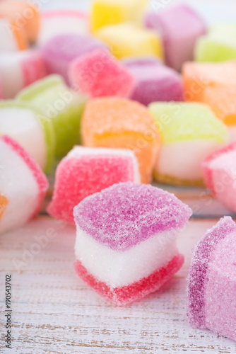 closeup colorful candy and jelly sweet on wooden