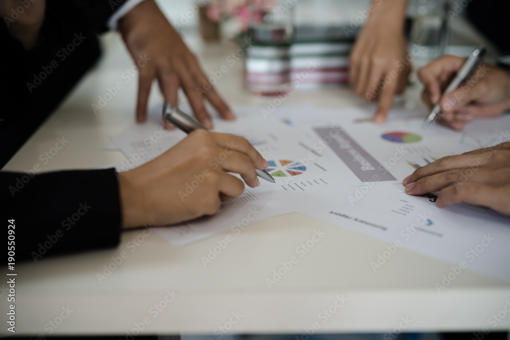 Hand of businessman point to graph. is discussing together in conference room talk about Report, Sales, Target, Marketing, Concept. Hand of businessman point to graph. is discussing together in conference room talk about Report, Sales, Target, Marketing, Concept.