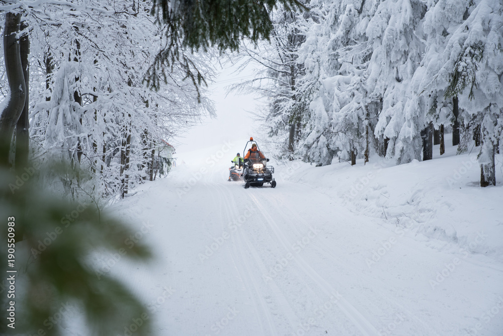 Man and snowmobile, white frozen winter nature