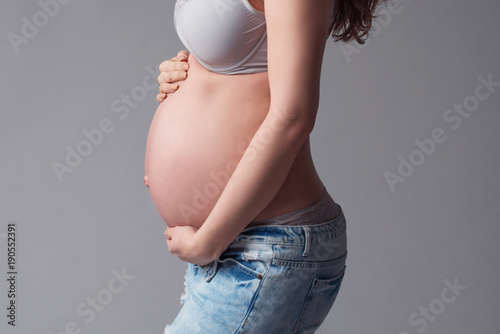 Pregnant woman touching her Belly. Pregnancy concept. Mom Expecting Baby. photo