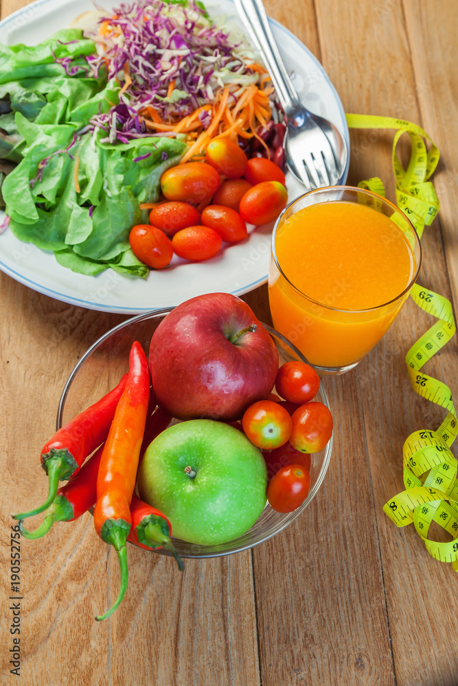 Healthy concept with mixed fruits and vegetables on wooden background Healthy concept with mixed fruits and vegetables on wooden background