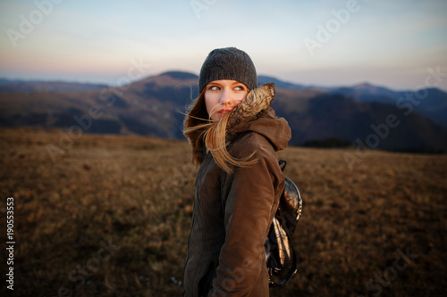 Portrait of a smiling happy woman. Shot of a young woman looking at the landscape while hiking in the mountains