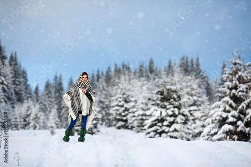 Happy young woman walking in winter time. Happy girl having fun in the snow. Snow covered trees in the winter sun light. Snowy pine trees on a winter landscape. snovy trees on winter mountains