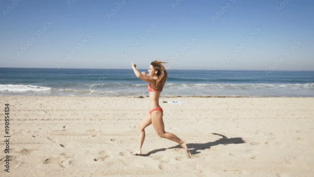 happy young woman runs at manhattan beach in california. summer time happy young woman runs at manhattan beach in california. summer time