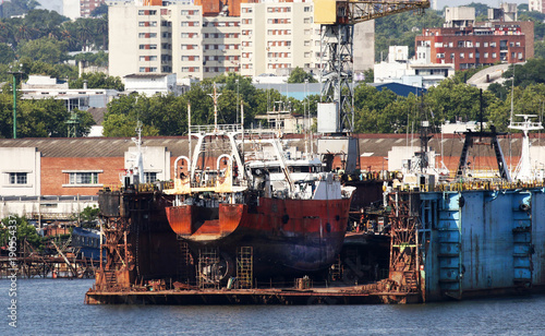 Dry dock shipyard in port of Montevideo, Uruguay. Old ship under repairs. 