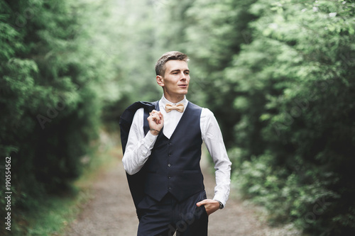 Young handsome man posing on mountain forest © olegparylyak