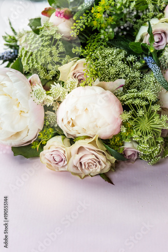 Bouquet of flowers from big peonies and pastel roses