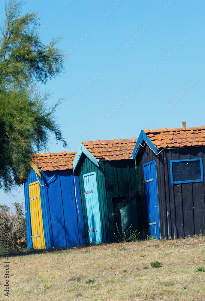 alignment of colored fisherman cabins on the seaside alignment of colored fisherman cabins on the seaside