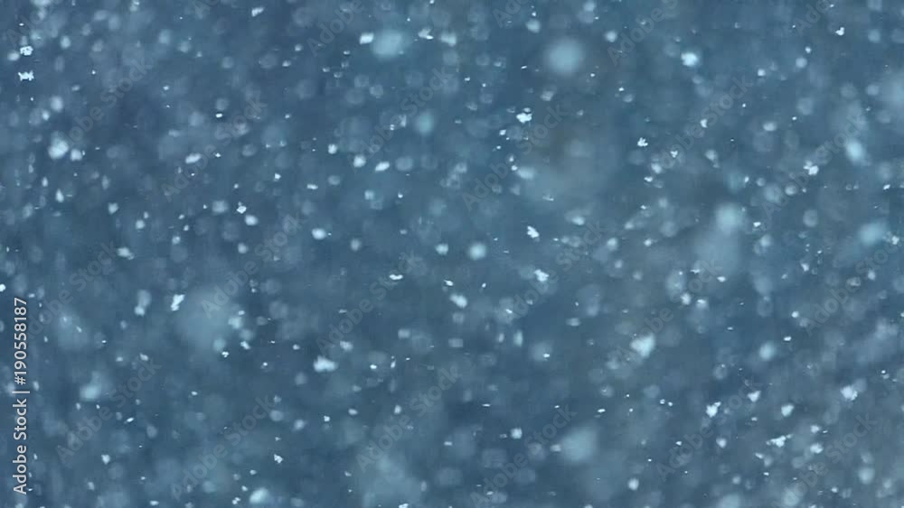 Slow motion snow falling, relaxing nature background, super-slow motion effect. If you are good with chroma keying you can use this as an overlay to get that magical snow globe feeling.