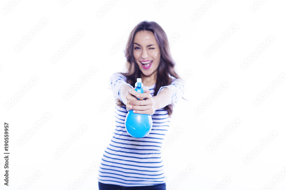 House cleaning. A cheerful beautiful and energetic young woman with a nebulizer in her hands is cleaning her apartment. Means to clean glass.