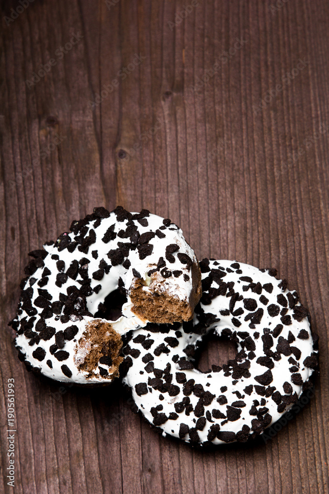 Traditional donuts on wooden background.  Tasty doughnuts with icing, copy space
