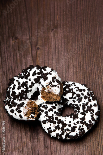 Traditional donuts on wooden background. Tasty doughnuts with icing, copy space