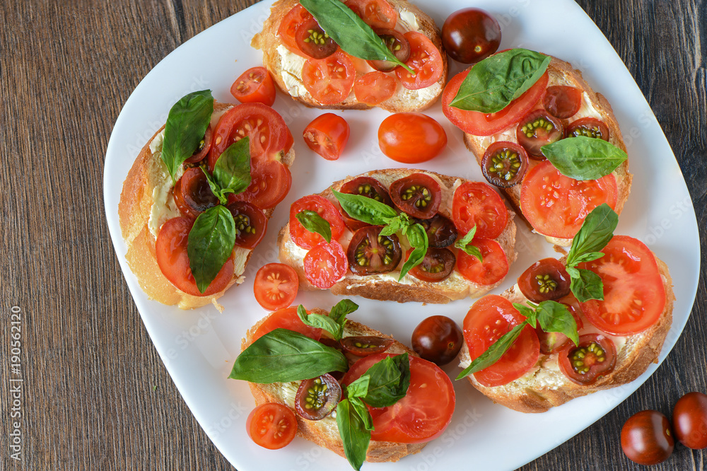 Sandwich with bread and butter, tomatoes and basil Sandwich with bread and butter, tomatoes and basil