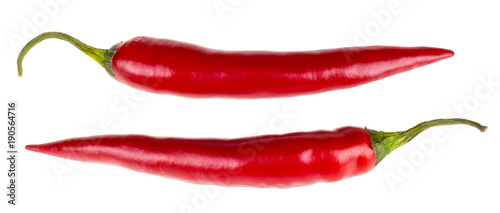 Healthy red hot chili peppers. Two spicy capsicums containing medicinal capsaicin. Isolated on a white background.