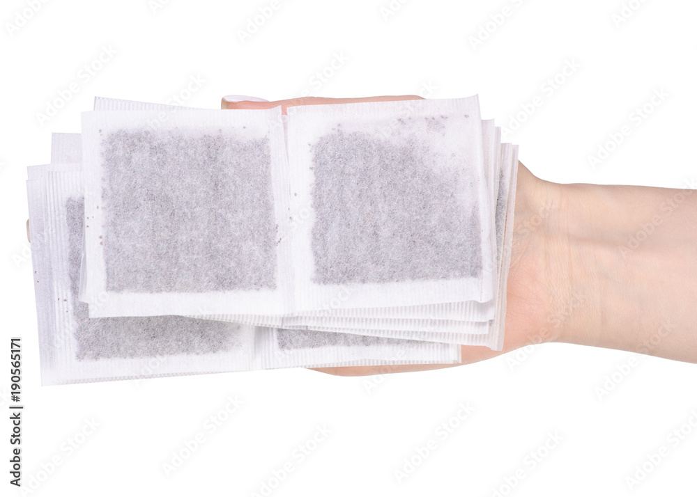 Sachets of black tea in a hand Sachets of black tea in a hand