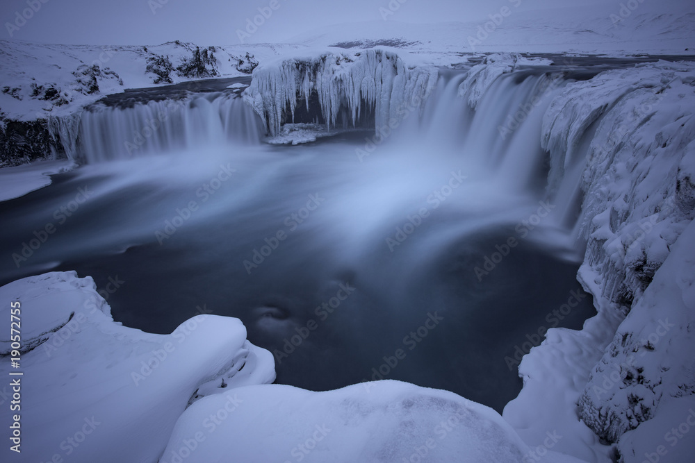 Frozen waterfall Godafoss in icey wonderland of iceland winter