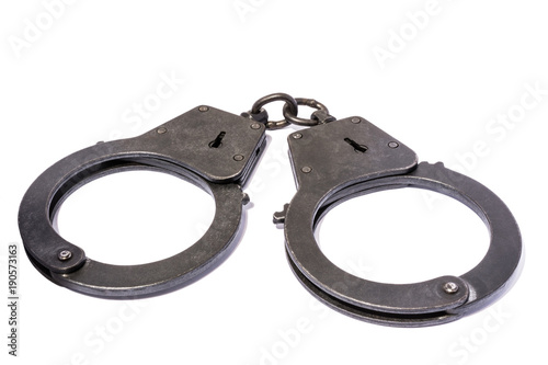 black metal handcuffs with small scratches on white background