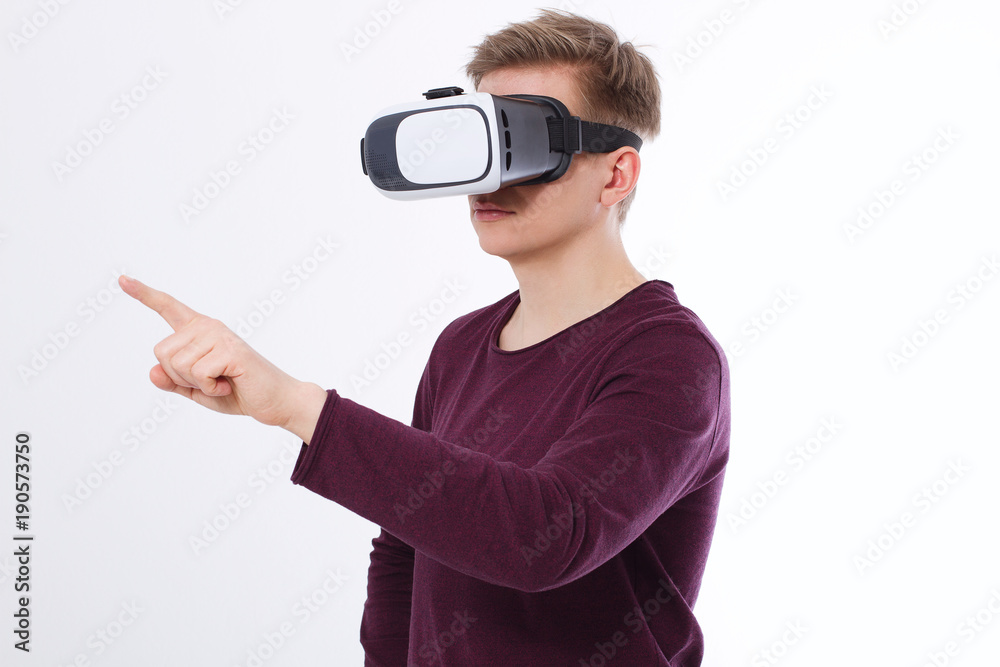 Young Man wearing virtual reality goggles and toch space by finger isolated on white background. VR concept and copy space. Selective focus. Blank template Shirt Young Man wearing virtual reality goggles and toch space by finger isolated on white background. VR concept and copy space. Selective focus. Blank template Shirt