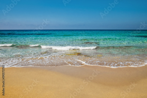 Sunny day on the beach blue sea orange sand