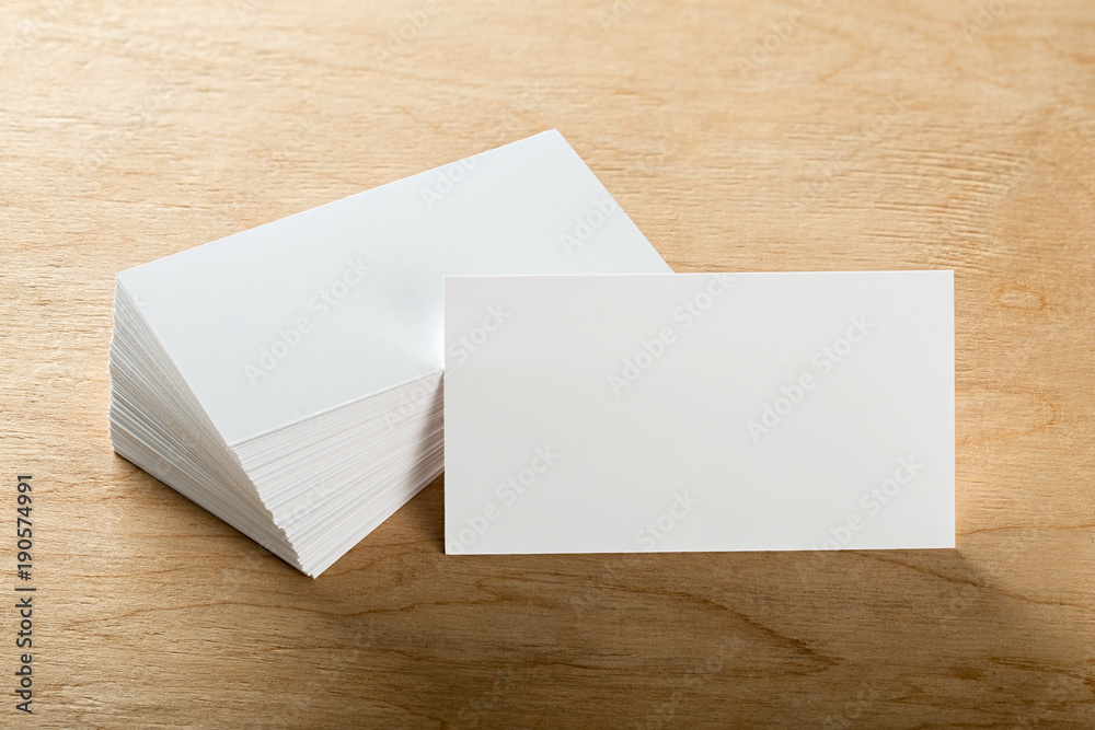 Blank business cards on a wooden surface Blank business cards on a wooden surface
