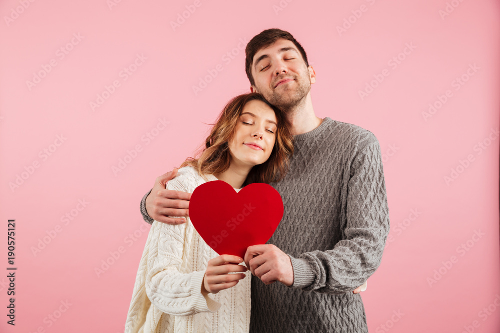 Portrait of smiling loving couple dressed in sweaters