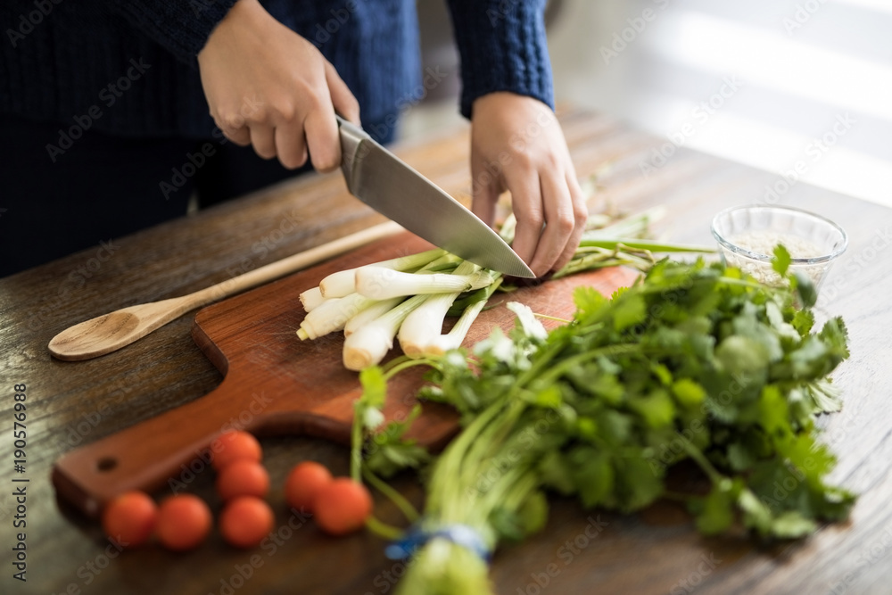 Woman chopping green onions