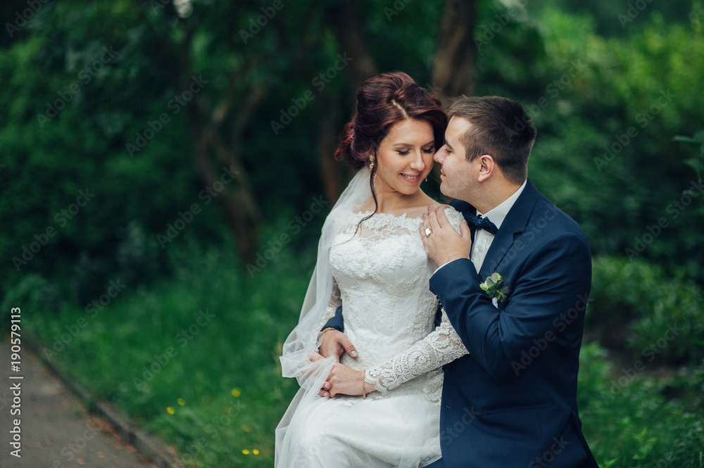 Look from above at beautiful wedding couple kissing in the eveni Look from above at beautiful wedding couple kissing in the eveni
