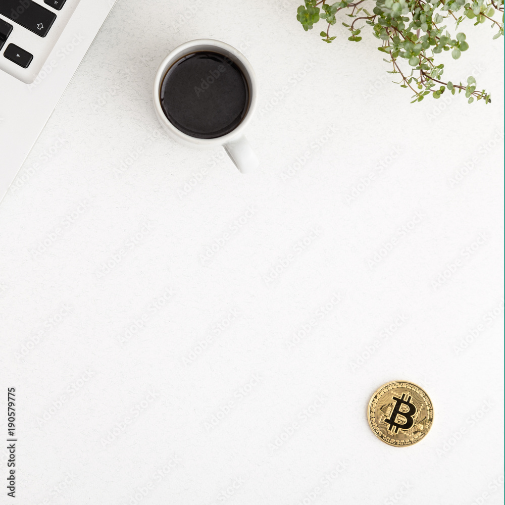 golden bitcoin on white office desk background. Cryptocurrency payment concept. Flat lay.