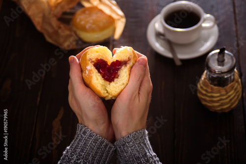Man hands holding donut in heart shape