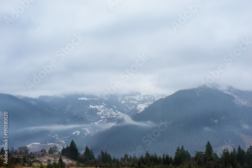 Beautiful view with morning fog in early spring, in Carpathian mountains, in Transylvania, Romania photo