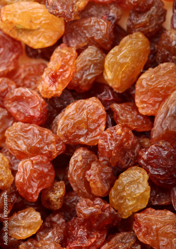 Brown raisin pile. Selective focus. Closeup photo image of brown raisin in a pile present a detail of texture .Texture of raisins