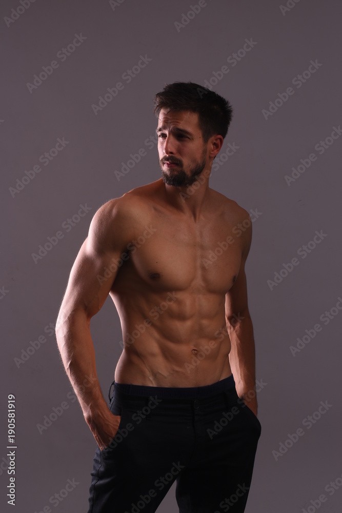 Shirtless athlete posing with flexing Abs