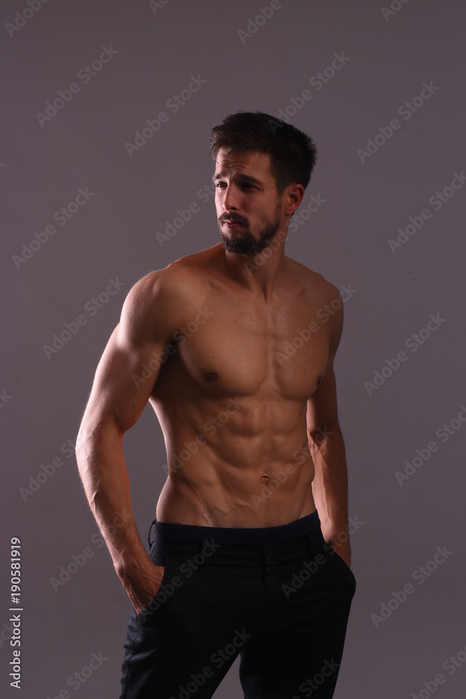 Shirtless athlete posing with flexing Abs Shirtless athlete posing with flexing Abs