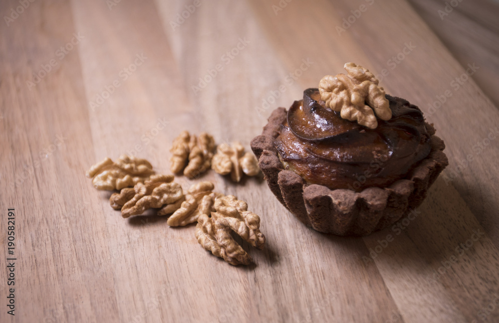 Delicious muffins with nuts placed on a wooden table Delicious muffins with nuts placed on a wooden table
