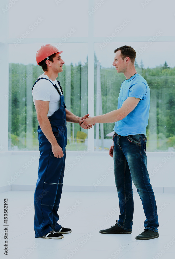 Customer Shaking Hands With Builder.