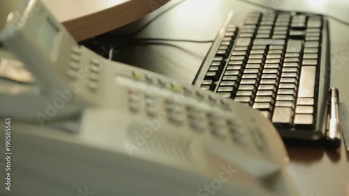 Teleshopping center worker discussing order details and typing in computer