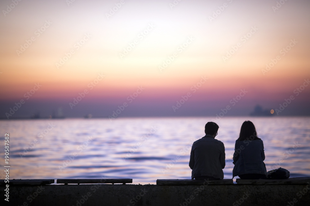 Couple looking with sunset