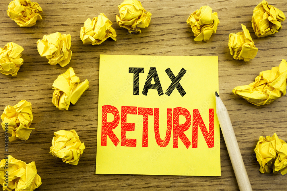 Naklejka premium Word, writing Tax Return. Business concept for Accounting Money Return written on sticky note paper on the wooden background. Folded yellow papers on the background