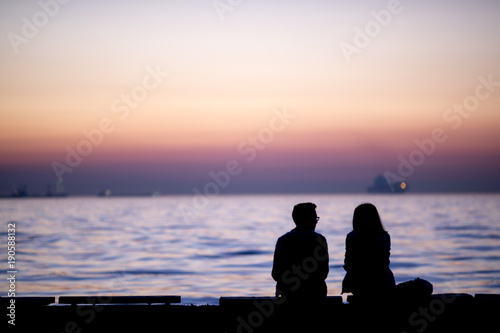 Couple looking with sunset