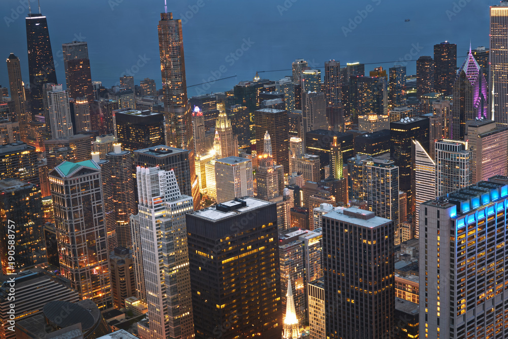 Chicago, Wind City at sunset. Aerial skyline, cityscape with rooftop buildings. Lake Michigan in sight