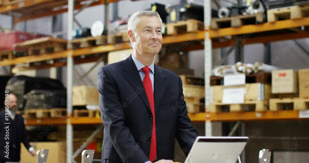 4k, Tired businessman with a concerned look working at a large warehouse. 4k, Tired businessman with a concerned look working at a large warehouse.