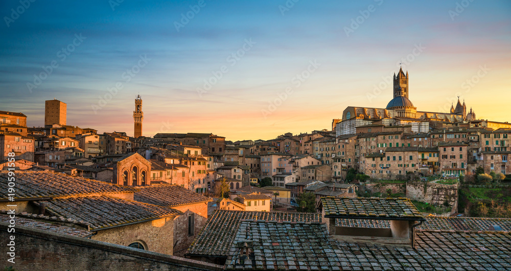 Siena sunset panoramic skyline. Mangia tower and cathedral duomo. Tuscany,