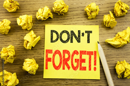 Word, writing Do Not Forget. Business concept for Reminder Message written on sticky note paper on the wooden background. Folded yellow papers on the background