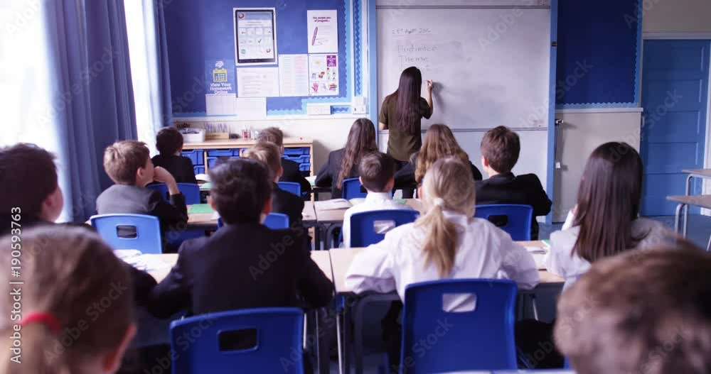 4k, Attractive female teacher teaching a classroom in front of a whiteboard. Slow motion.