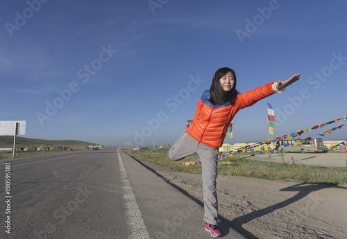 A Chinese girl practices yoga on the plateau photo