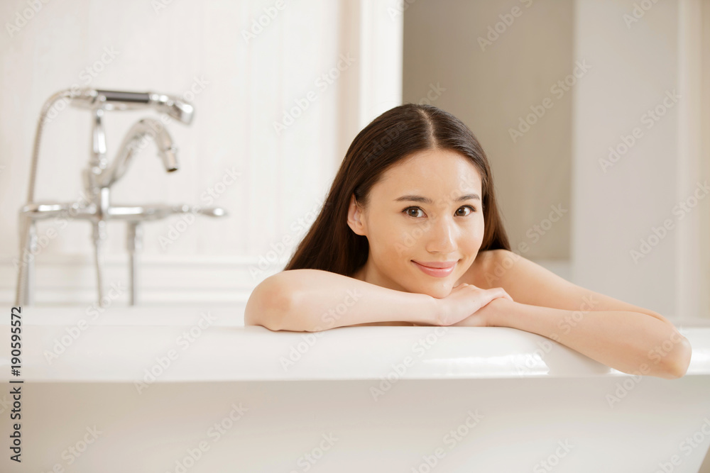 Portrait of beautiful young woman relaxing in bathtub Portrait of beautiful young woman relaxing in bathtub