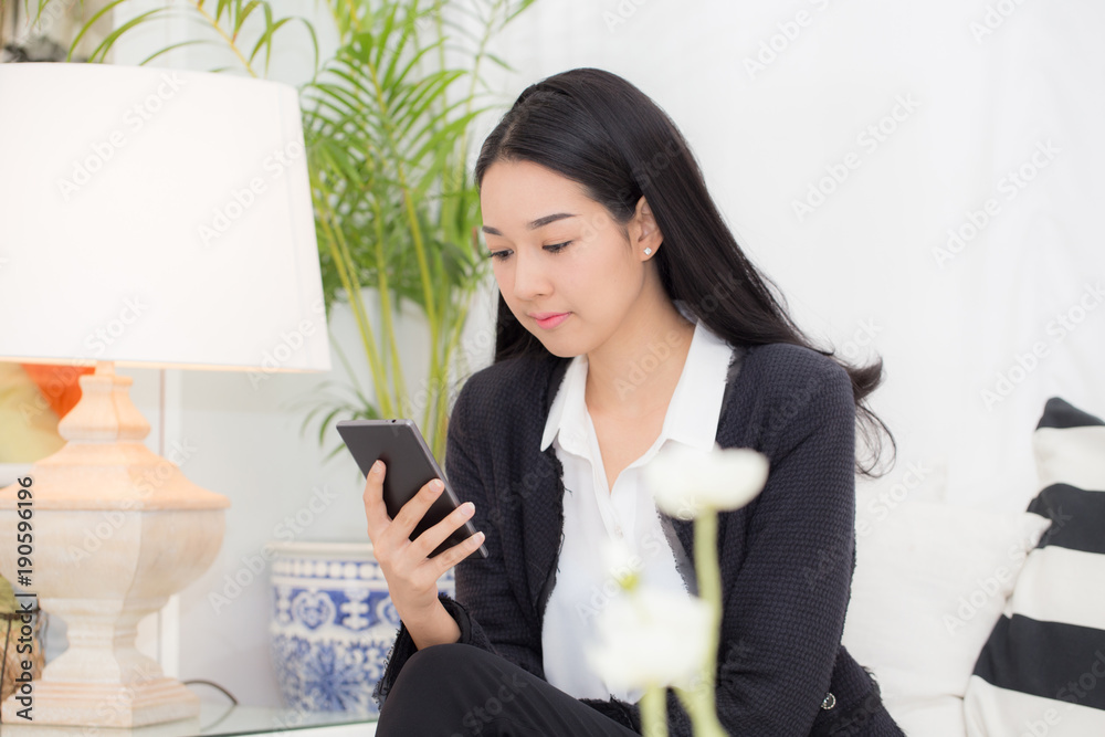Happy Business Asian woman looking mobile phone in coffee shop Happy Business Asian woman looking mobile phone in coffee shop