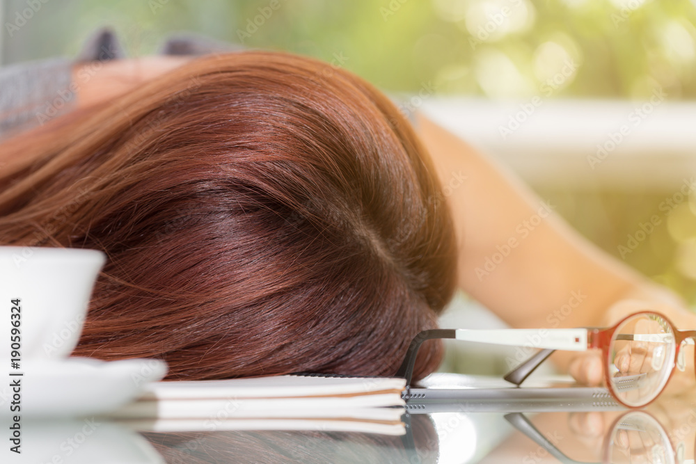 Fototapeta premium Asian business woman sleep at work table