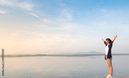 Girl standing against the blue sky, Freedom concept