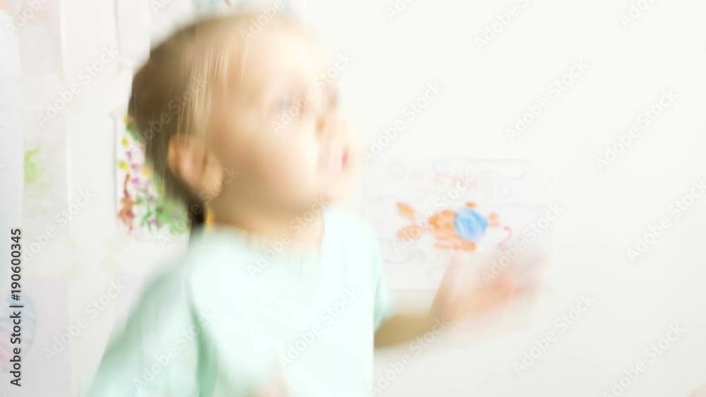 Happy young mother and daughter playing, drawing, playing games on your smartphone braid braids, read. Happy young mother and daughter playing, drawing, playing games on your smartphone braid braids, read.